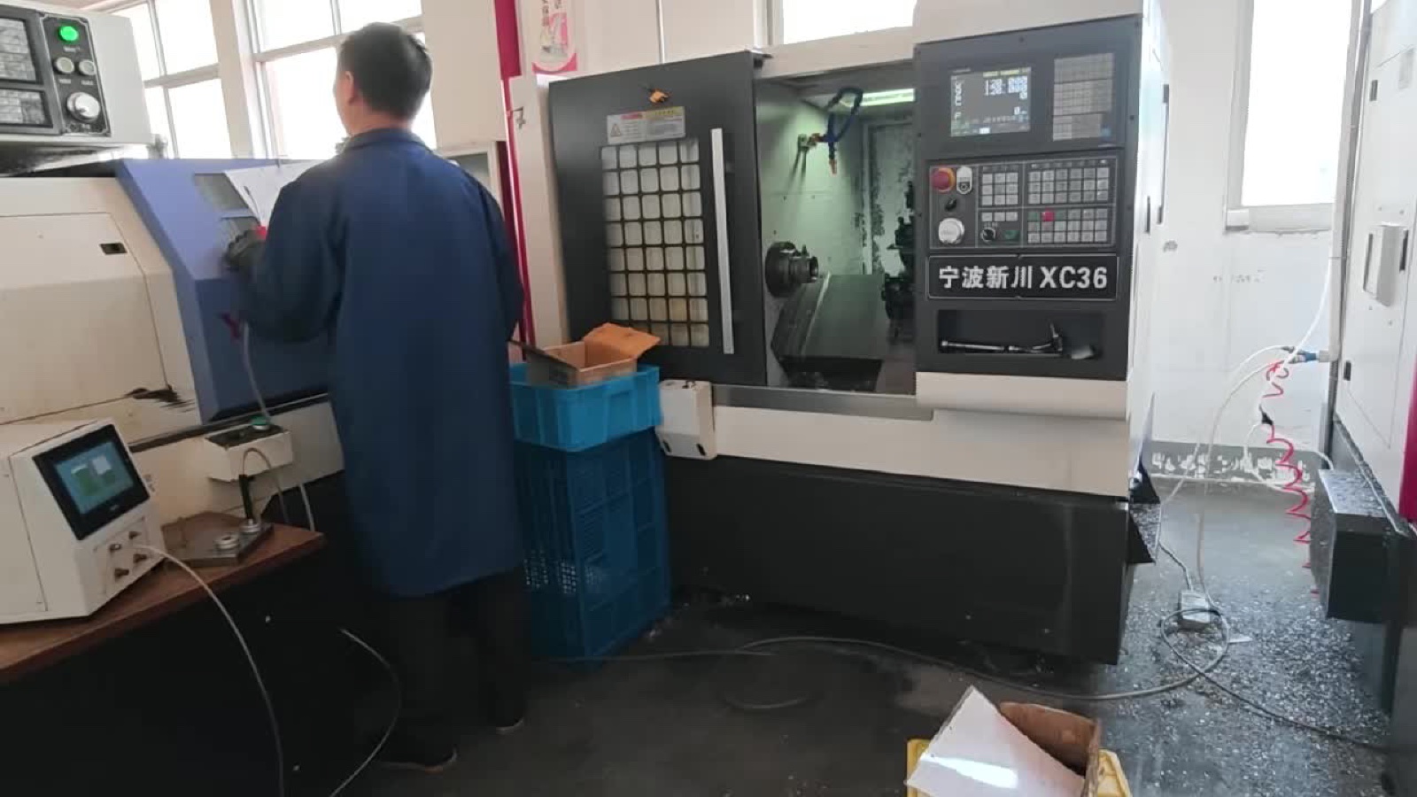 CNC operator running a Xinchuan XC36 turning machine